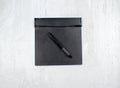 Graphic tablet with pen for illustrators and designers, isolated on a wooden background.