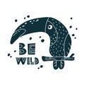 Graphic toucan, black cartoon bird on branch with lettering Be wild. Cute kids illustration