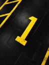 Graphic yellow numbers painted on a stark black background