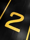 Graphic yellow numbers painted on a stark black background