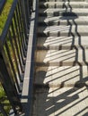 Street stairs with metal handrail and its graphical shadow