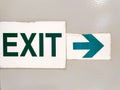 Graphically interesting exit sign on painted metal surface. Royalty Free Stock Photo