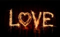 graphics of a burning love inscription on a dark background