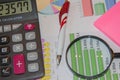 Graphics calculator, magnifier and pen. Analyzing financial data and counting on calculator
