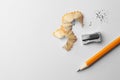 Graphite pencil, shavings and sharpener on white background, flat lay. Space for text Royalty Free Stock Photo