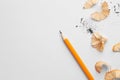 Graphite pencil and shavings on white background, flat lay. Space for text Royalty Free Stock Photo