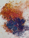 Graphite shavings of yellow red blue and violet spread in abstract form slightly intermixed Royalty Free Stock Photo