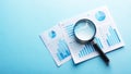 Analyzing Business Charts and Graphs with Magnifying Glass Royalty Free Stock Photo