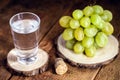 Grappa or Graspa is a brandy made from grapes. Glass with alcoholic drink and grapes beside Royalty Free Stock Photo