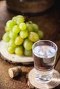 Grappa or Graspa is a brandy made from grapes. Glass with alcoholic drink and grapes beside Royalty Free Stock Photo
