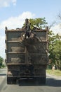 Grapple truck unloads scrap industrial metal for recycling. Manipulator with hydraulic magnet crab against sky. Crane garbage Royalty Free Stock Photo