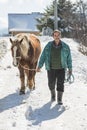 Grashevo village in Rhodope mountains, Bulgaria - February 8, 2020: A villager with his horses in a snowy cold day. Rural scene