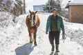 Grashevo village in Rhodope mountains, Bulgaria - February 8, 2020: A villager with his horses in a snowy cold day. Rural scene