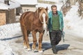 Grashevo village in Rhodope mountains, Bulgaria - February 8, 2020: A villager with his horses in a snowy cold day. Rural scene