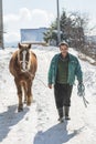 Grashevo village in Rhodope mountains, Bulgaria - February 8, 2020: A villager with his horses in a snowy cold day. Rural scene