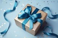 Grasping paper gift box, blue bow, sequins on pastel. Top-view elegance captured.