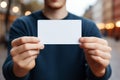 Grasping potential: Cropped shot captures male hands holding blank card for customizable content.