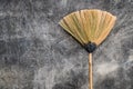 A grass broom lay against the old cement wall. Royalty Free Stock Photo