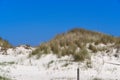 Grass covered dunes at the beautiful white sand beach Royalty Free Stock Photo