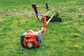 Grass cutter / brush cutter for trimming overgrown grass lay on the lawn