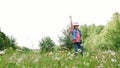 In the grass, among the daisies, in the meadow, dancing, jumping, having fun, a pretty girl, about seven years old. She Royalty Free Stock Photo