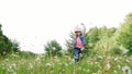 In the grass, among the daisies, in the meadow, dancing, jumping, having fun, a pretty girl, about seven years old. She Royalty Free Stock Photo