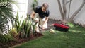 Plumber Man fixing Sprinkler Head in backyard