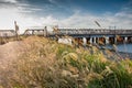 Grass field in the sunset with river and railway in the background Royalty Free Stock Photo