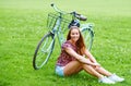 The grass is always greener where youre happiest. Shot of a young woman relaxing on the grass while out for bike ride in