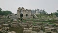 grass growing on the ruins and remains of Yuanming Yuan with Western-style architecture including arches, columns, and