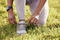 Grass, hands and tie shoes for fitness, training or start exercise outdoor in nature in summer. Legs, person and tying