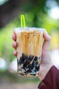 Grass Jelly With Fresh Milk & Brown Sugar woman hand hold