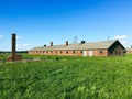 Grass landscape and brick barrack in Auschwitz-Birkenau concentration camp in Poland Royalty Free Stock Photo