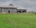 Grass pasture with farm buildings