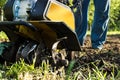 Grass and plowed soil nuggets during motor cultivator spring garden or farm work