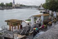 Grass-roofed houseboat moored in sight of Pont Alexandre III on