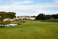 Grass, sky and trees on golf course with building, lake and natural landscape with park in summer. Nature, green and Royalty Free Stock Photo