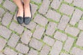 Grass Stone Floor texture pavement design and woman's feet. Royalty Free Stock Photo