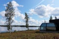 Grass and trees next to a cabin at Lake Ranuanjarvi, Finland