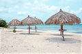 Grass umbrellas at the beach on Aruba island Royalty Free Stock Photo