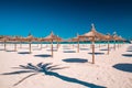 Grass umbrellas at the summer beach on Playa de Muro. Mallorca, Spain Royalty Free Stock Photo