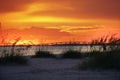 The glowing orange sunset over the bridge that leads to Sanibel and Captiva islands from Ft.Myers Beach, Florida.