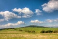 Grassfield and blue sky with clouds Royalty Free Stock Photo