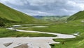 a grassland with a wriggle stream