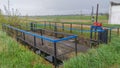 On the grassy bank of the reservoir, a concrete hydraulic structure was built with a damper on a worm mechanism to regulate the wa