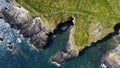 Grassy cliffs on the Atlantic Ocean coast. Landscape of Ireland from a height. Seaside rocks. Aerial photo Royalty Free Stock Photo