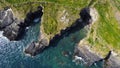 Grassy cliffs on the Atlantic Ocean coast. Landscape of Ireland from a height. Seaside rocks. Drone photo Royalty Free Stock Photo