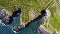 Grassy cliffs on the Atlantic Ocean coast. Landscape of Ireland from a height. Seaside rocks. Drone point of view Royalty Free Stock Photo