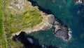 Grassy cliffs on the Atlantic Ocean coast. Landscape of Ireland from a height. Seaside rocks. Drone point of view. View from above Royalty Free Stock Photo