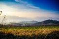 Grassy Field With Mountains in Background Royalty Free Stock Photo